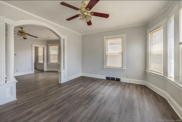 wooden floor in an empty room with a window