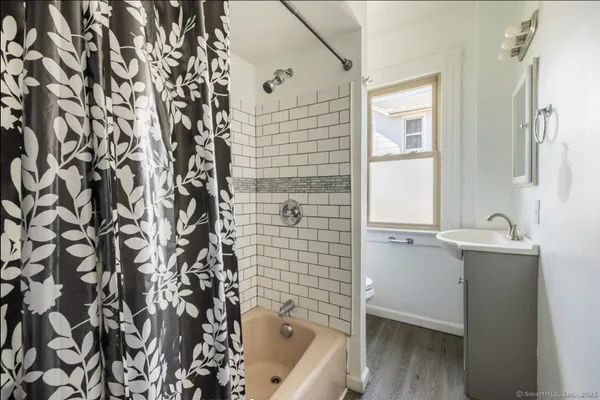 a bathroom with a bathtub and shower