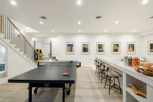 a kitchen with stainless steel appliances kitchen island lots of wooden furniture a dining table and chairs