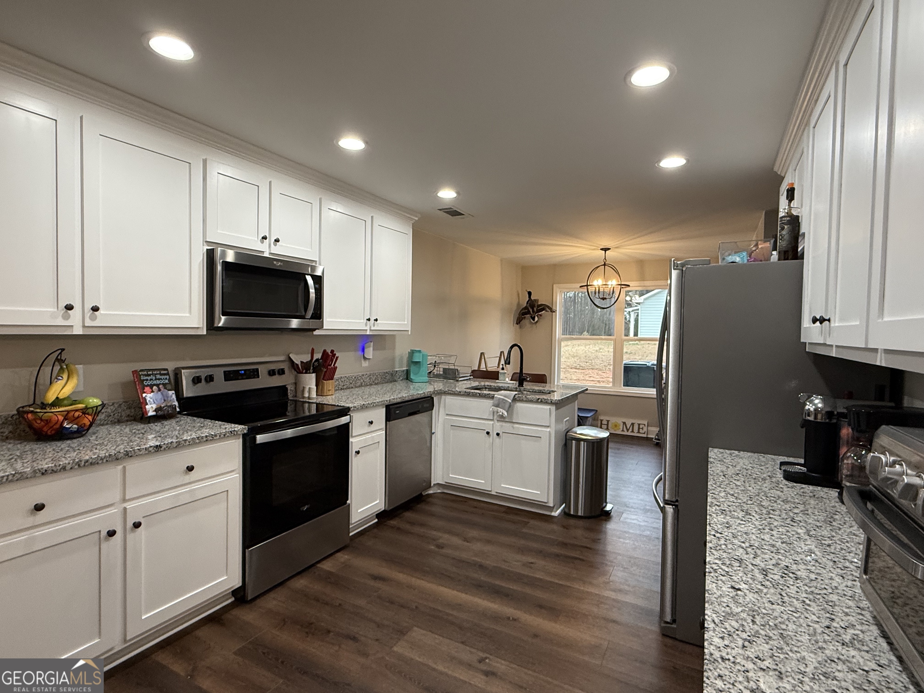 712 Scott Mill Road Hartwell, GA 30643 - Photo 11 of 31 a kitchen with sink a microwave and cabinets