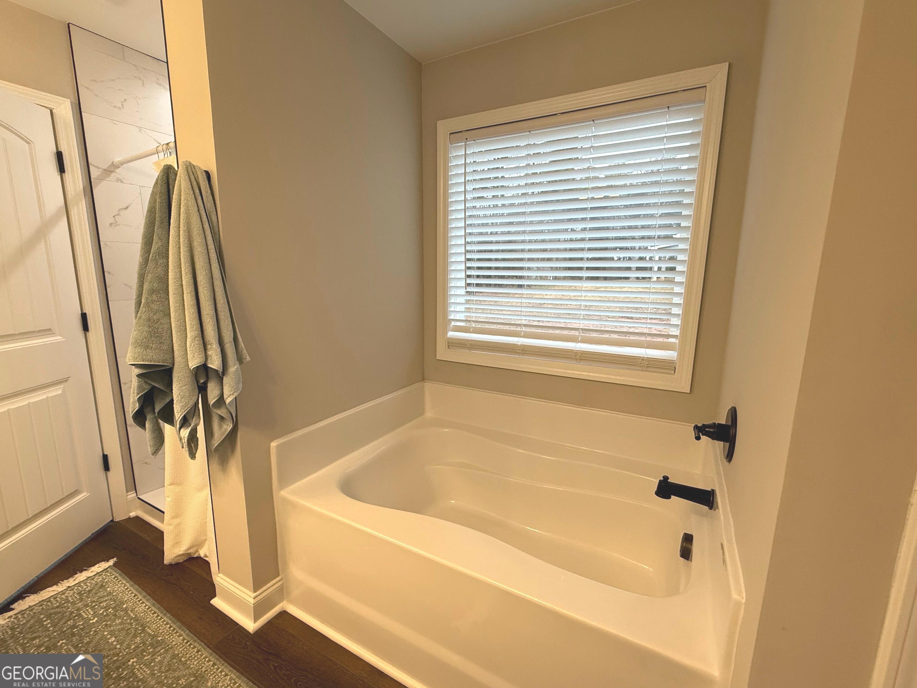 712 Scott Mill Road Hartwell, GA 30643 - Photo 20 of 31 a bathroom with a bathtub and a shower