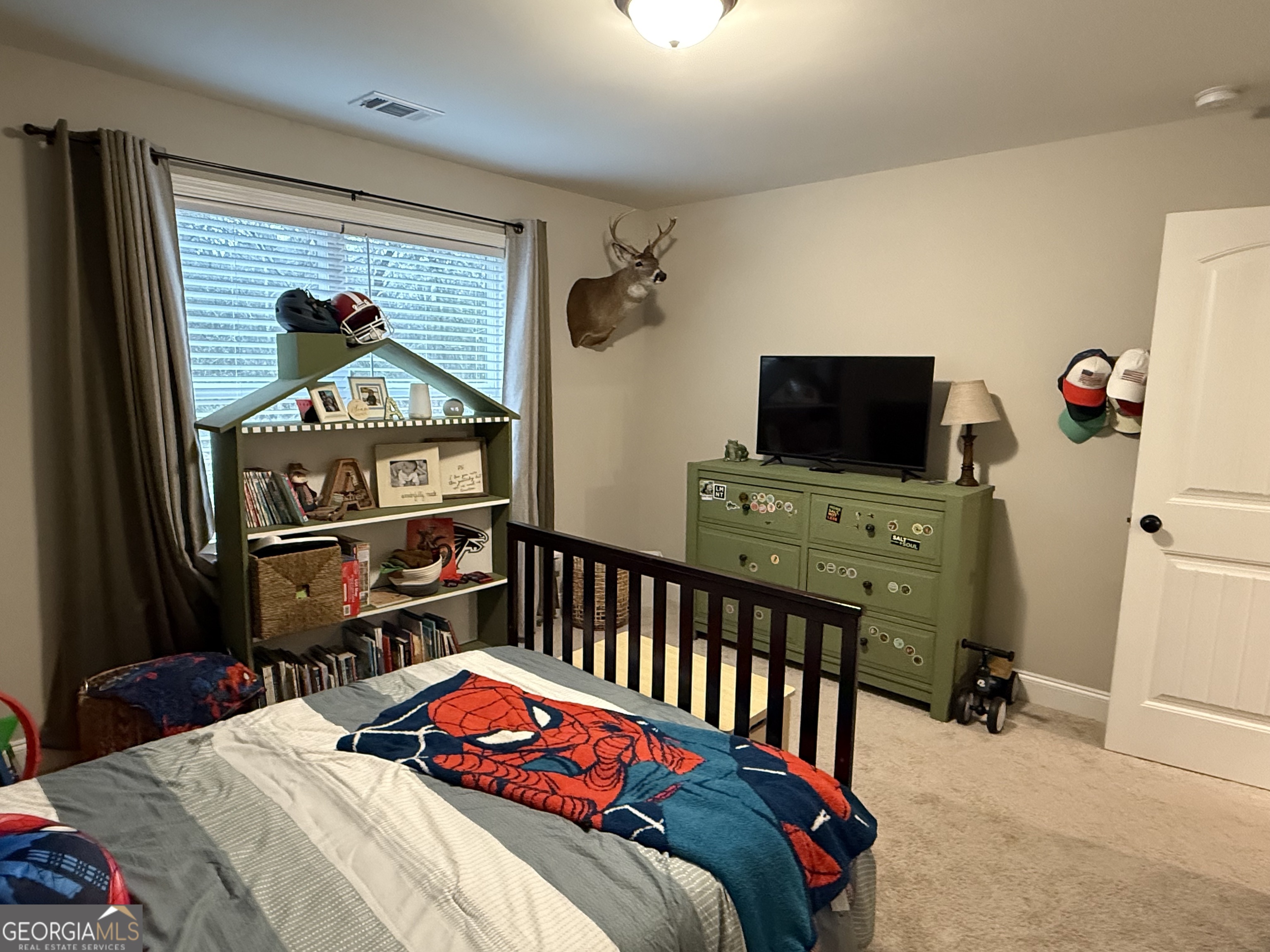 712 Scott Mill Road Hartwell, GA 30643 - Photo 26 of 31 a bedroom with a bed and flat tv screen on the dresser