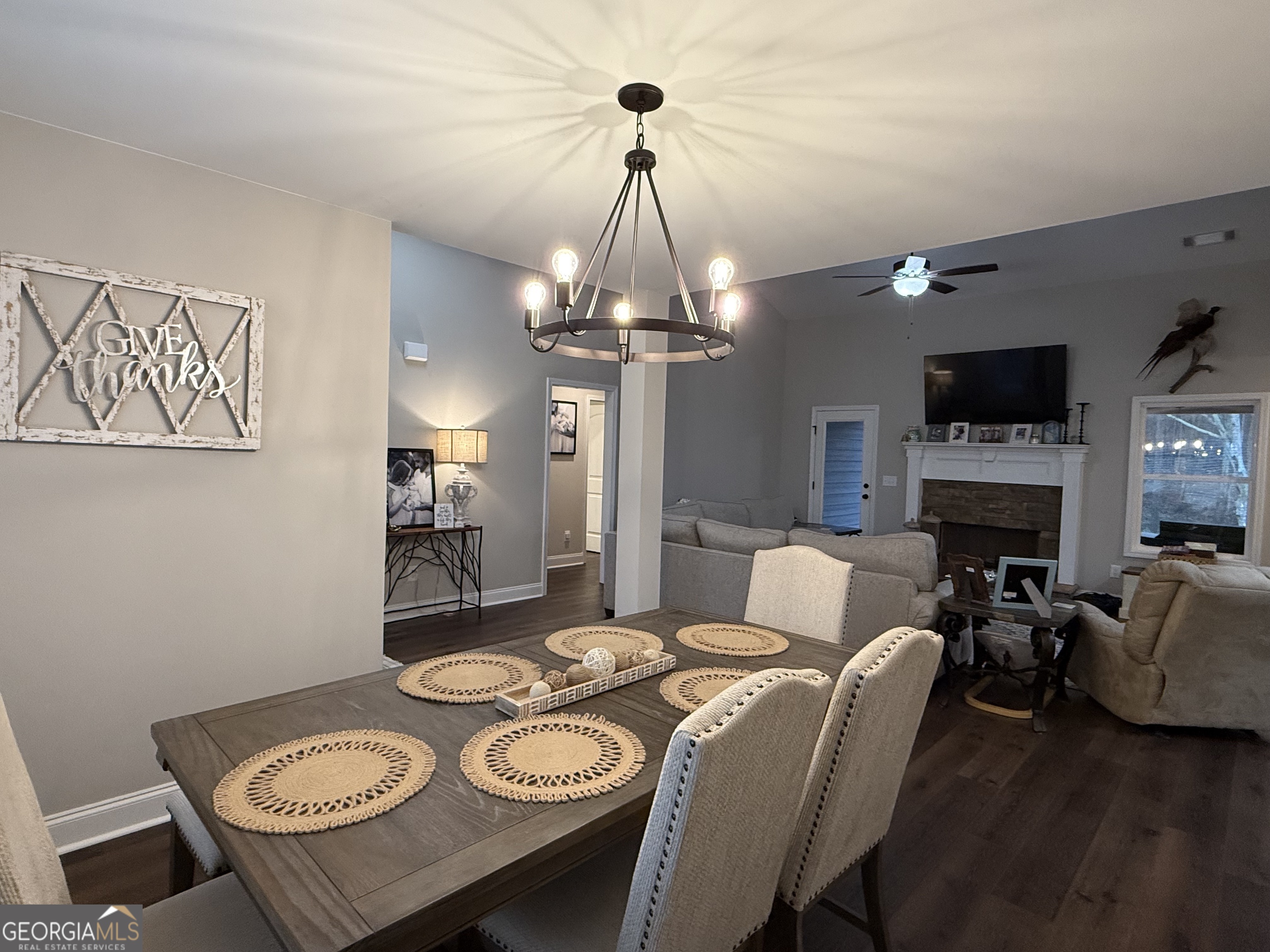 712 Scott Mill Road Hartwell, GA 30643 - Photo 4 of 31 a view of a dining room with furniture a chandelier and wooden floor