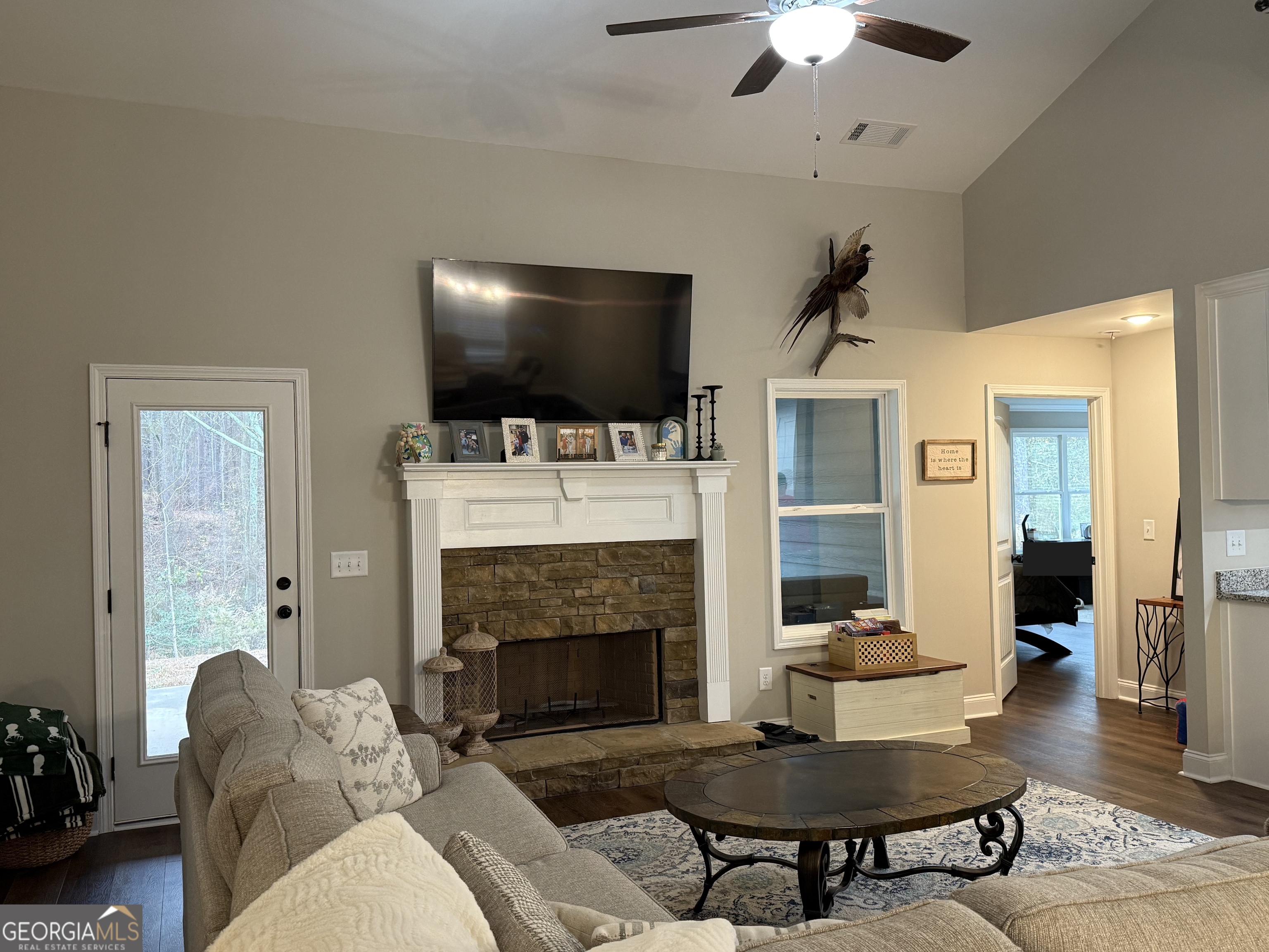 712 Scott Mill Road Hartwell, GA 30643 - Photo 7 of 31 a living room with furniture a flat screen tv and a fireplace