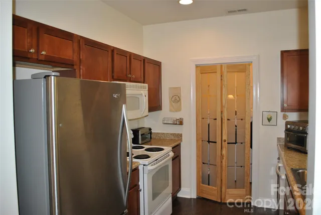 a kitchen with stainless steel appliances a refrigerator and a stove top oven