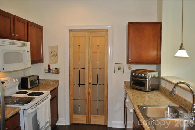 a kitchen with a refrigerator stove and sink