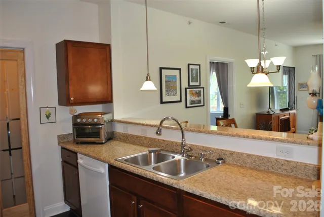 a kitchen with sink a counter and cabinets