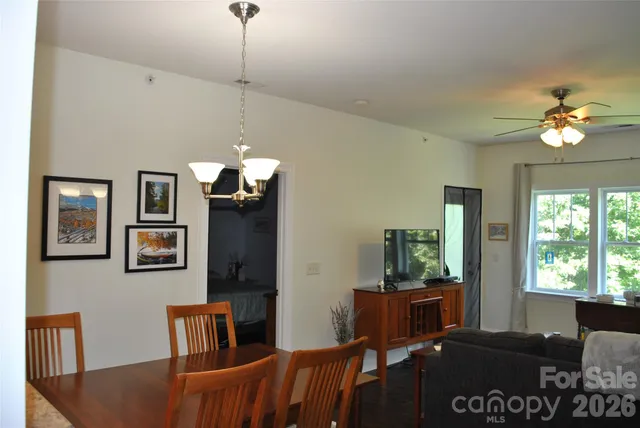 a living room with furniture a window and a chandelier
