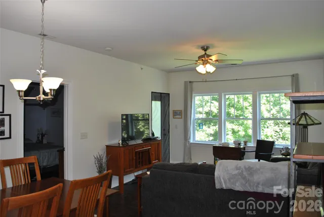 a living room with furniture a window and a chandelier