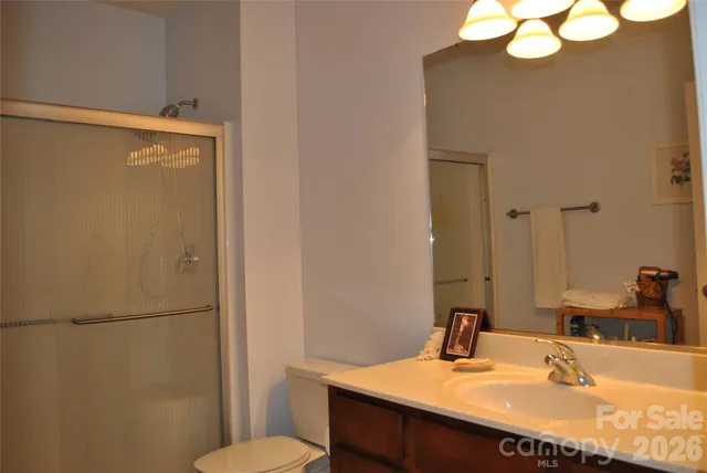 a bathroom with a sink vanity mirror and toilet