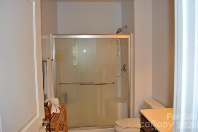 a bathroom with a shower and a toilet