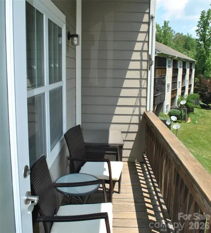 a balcony view with a seating space