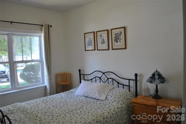 a bedroom with a bed and window