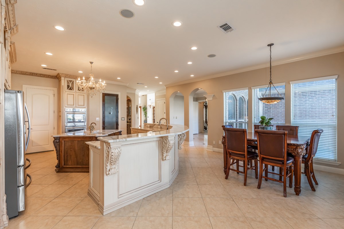 10940 Sheila Lane Beaumont, TX 77705 - Photo 15 of 50 a kitchen with stainless steel appliances kitchen island granite countertop a table and chairs