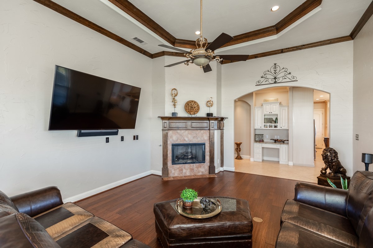 10940 Sheila Lane Beaumont, TX 77705 - Photo 21 of 50 a living room with furniture a flat screen tv and a fireplace