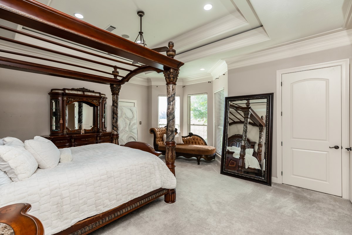 10940 Sheila Lane Beaumont, TX 77705 - Photo 26 of 50 a spacious bedroom with a bed a couch and dresser