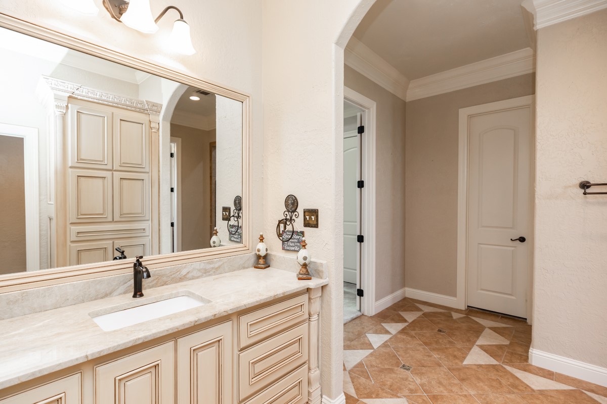10940 Sheila Lane Beaumont, TX 77705 - Photo 29 of 50 a bathroom with a granite countertop sink and a mirror
