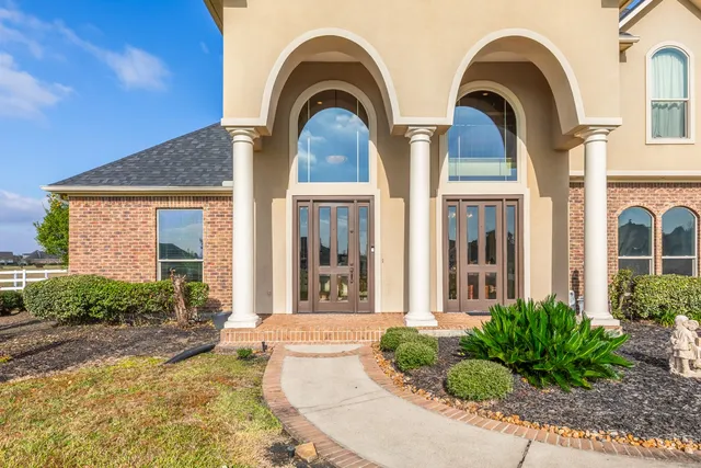 a view of a hallway with wooden floor and a living room