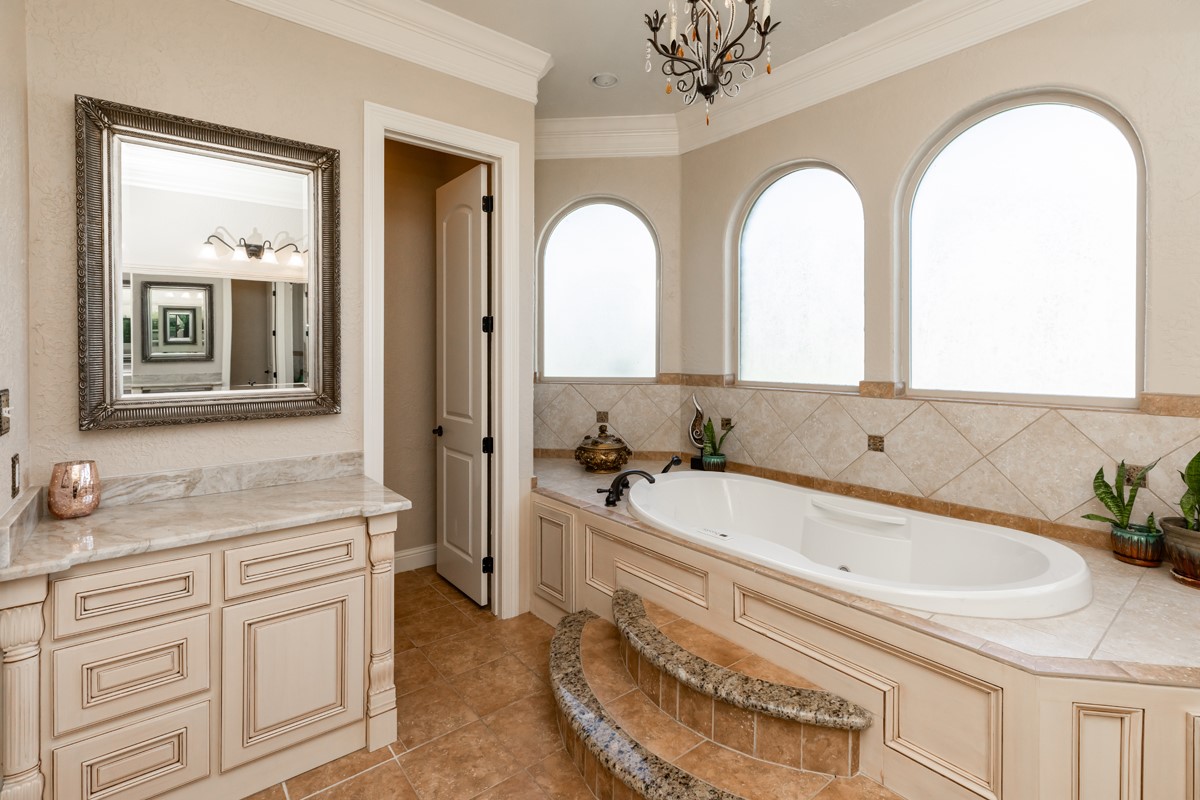 10940 Sheila Lane Beaumont, TX 77705 - Photo 32 of 50 a bathroom with a granite countertop sink a mirror and a bathtub