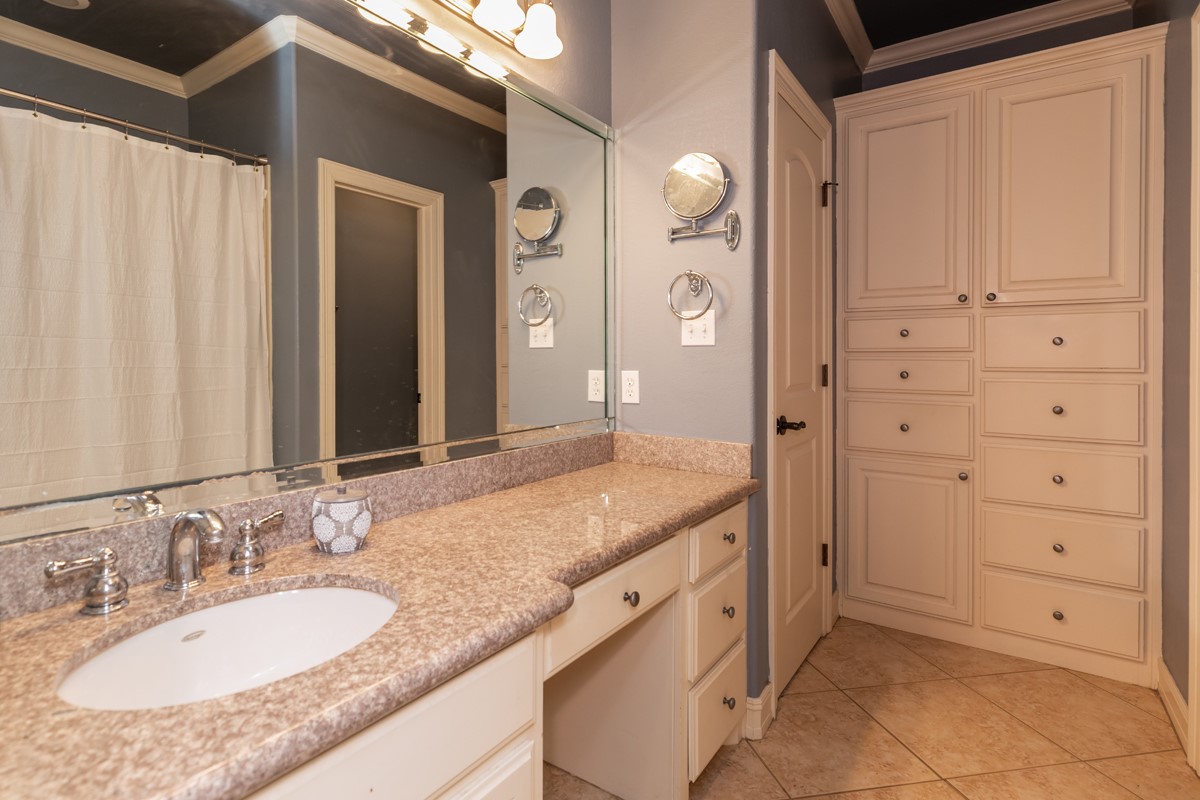 10940 Sheila Lane Beaumont, TX 77705 - Photo 42 of 50 a bathroom with a granite countertop sink and a mirror