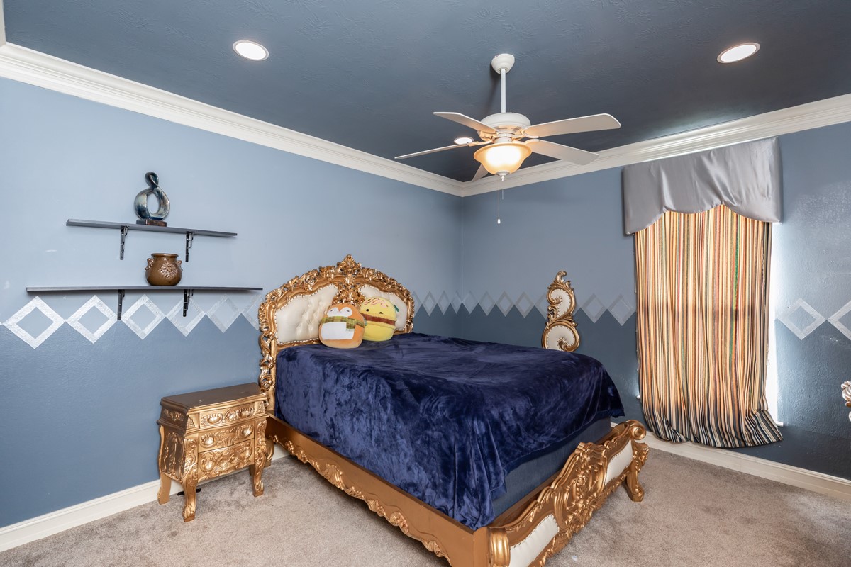 10940 Sheila Lane Beaumont, TX 77705 - Photo 43 of 50 a bedroom with a bed and a chandelier