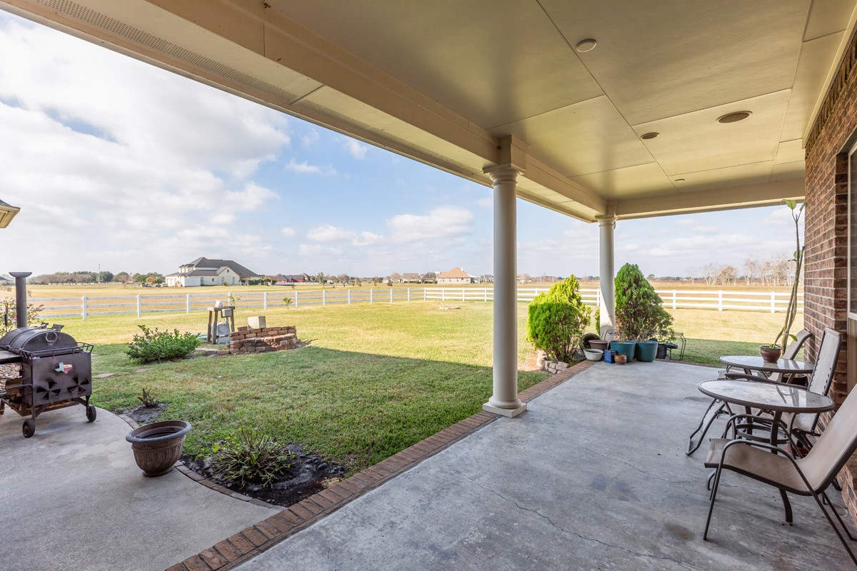 10940 Sheila Lane Beaumont, TX 77705 - Photo 45 of 50 a view of a patio with lawn chairs and couches with wooden floor