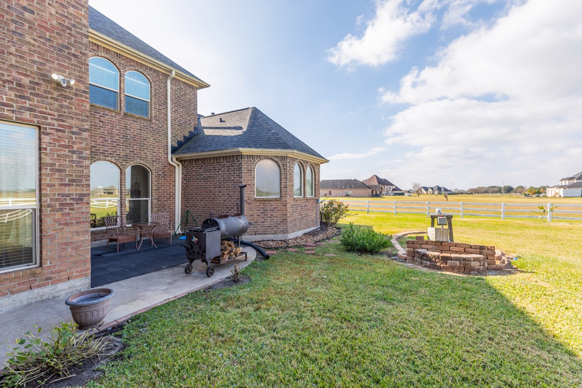 10940 Sheila Lane Beaumont, TX 77705 - Photo 46 of 50 a view of a house with a yard and a patio