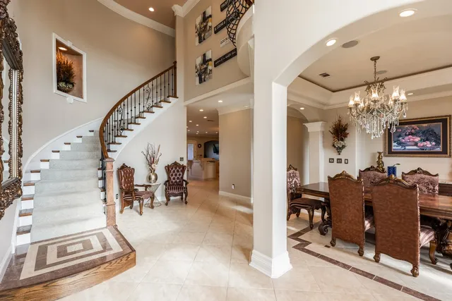 a view of a dining room with furniture and chandelier