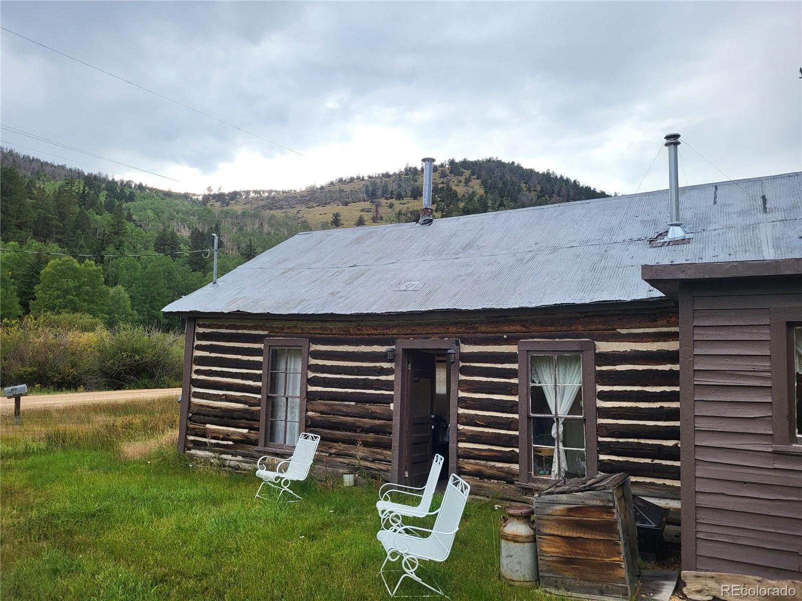 a backyard of a house with table and chairs