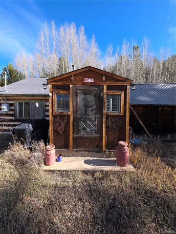 a view of a house with yard and sitting area