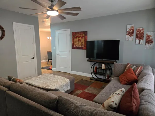 a living room with furniture and a flat screen tv