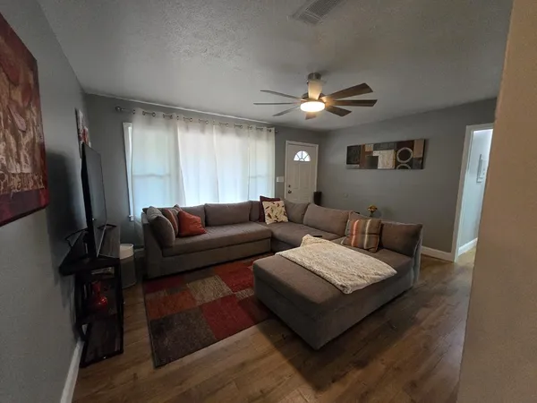 a living room with furniture and a flat screen tv