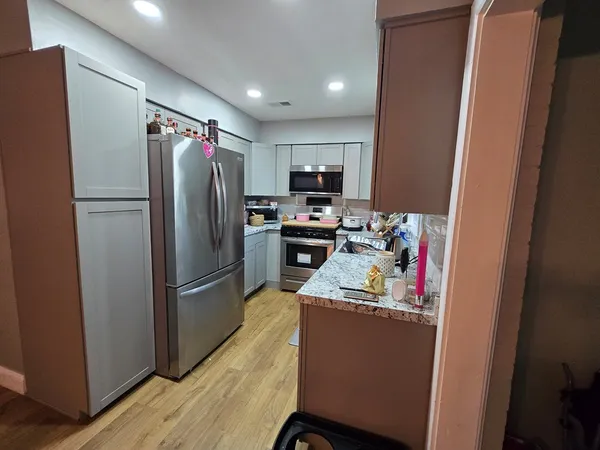 a kitchen with refrigerator and microwave