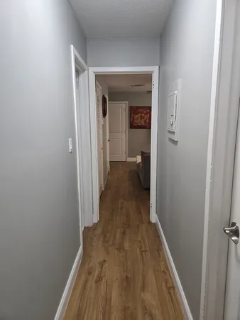 a view of a room with wooden floor