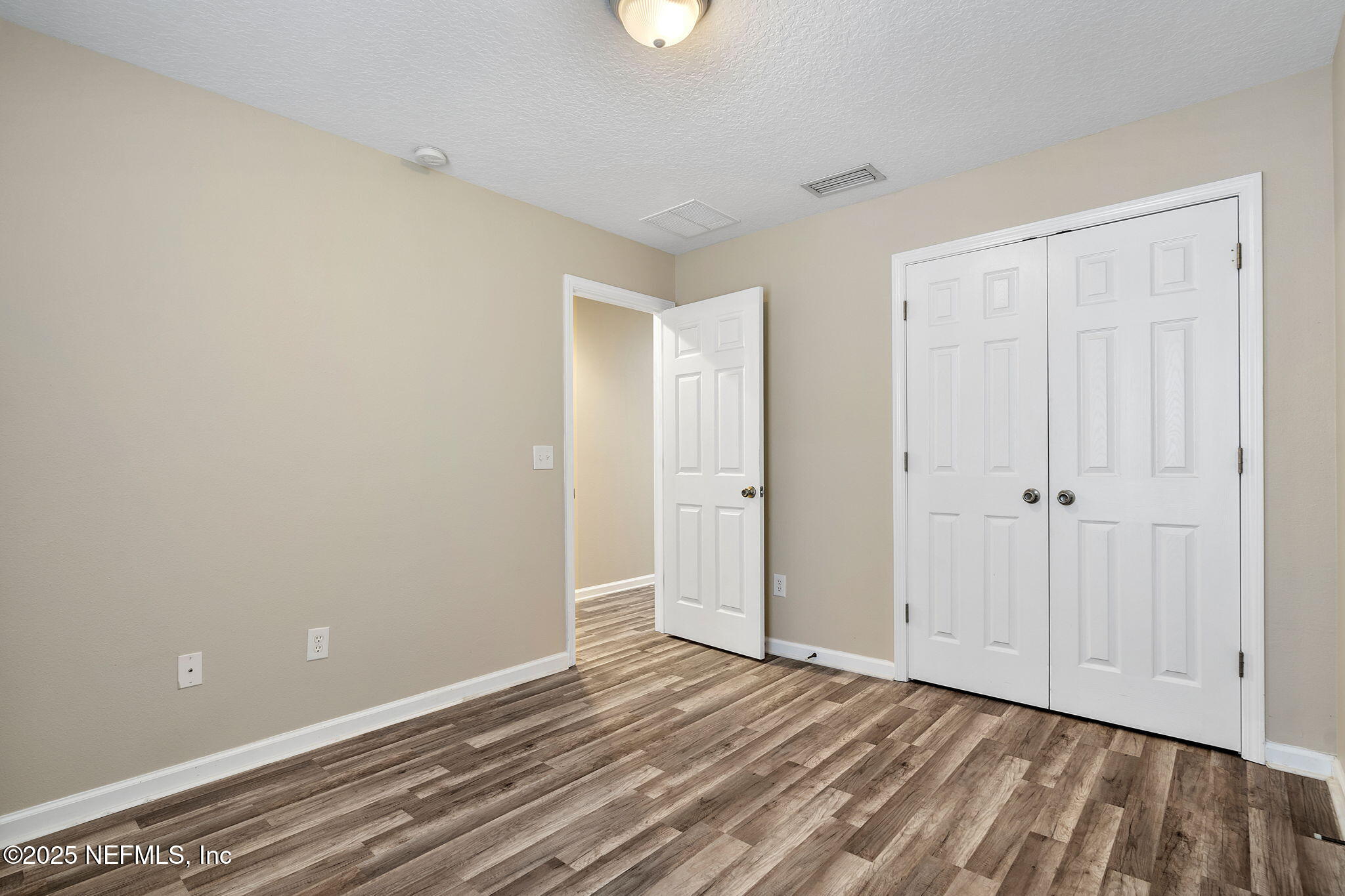 6700 Bowden Road, Unit 403 Jacksonville, FL 32216 - Photo 17 of 28 a view of an empty room with wooden floor