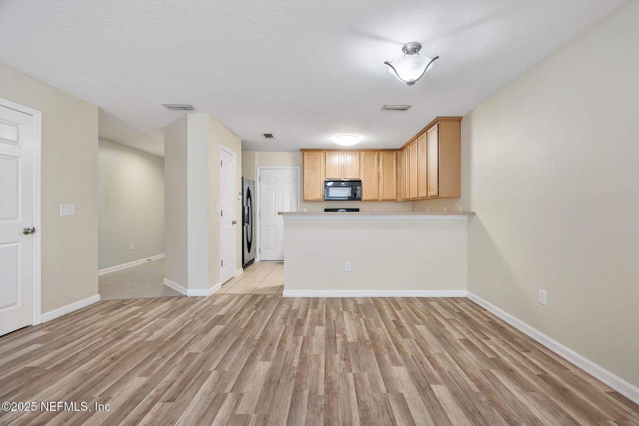 6700 Bowden Road, Unit 403 Jacksonville, FL 32216 - Photo 7 of 28 Living to Kitchen