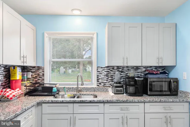 a kitchen with a sink and a stove top oven