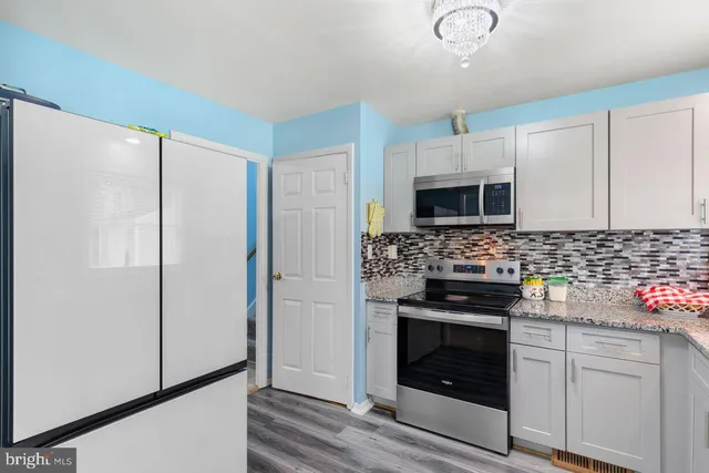 a bed room with a bed and a refrigerator