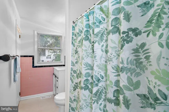 a bedroom with two beds and a window