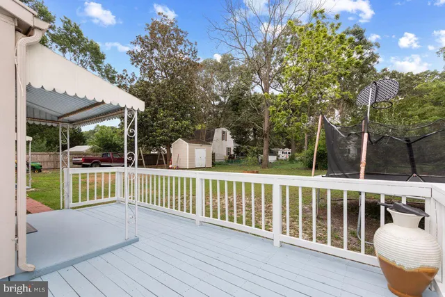 a view of a house with a yard and deck