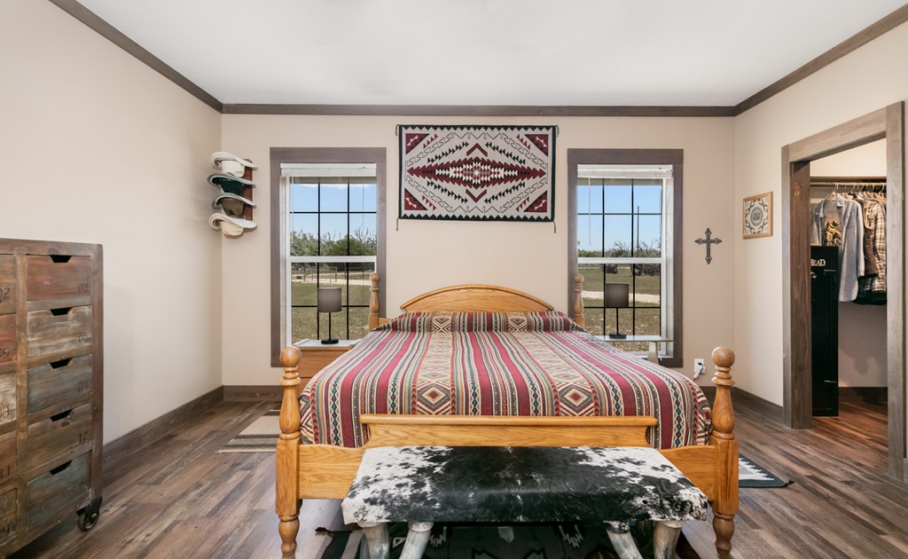 134 Concho Trail Harper, TX 78631 - Photo 12 of 31 a bedroom with a bed and wooden floor