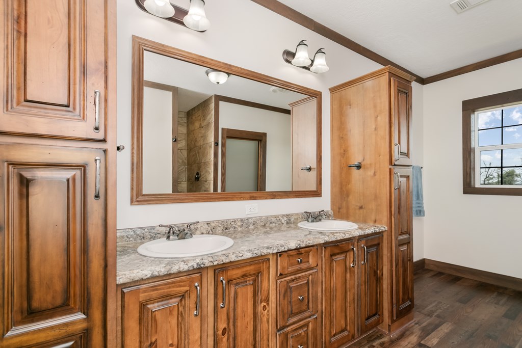 134 Concho Trail Harper, TX 78631 - Photo 13 of 31 a bathroom with a granite countertop sink and a mirror