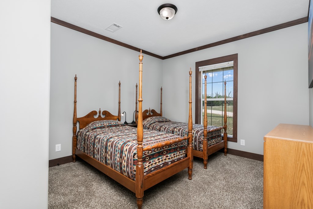 134 Concho Trail Harper, TX 78631 - Photo 15 of 31 a bedroom with a bed and a window