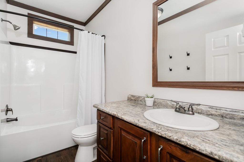 134 Concho Trail Harper, TX 78631 - Photo 16 of 31 a bathroom with a granite countertop sink toilet and shower