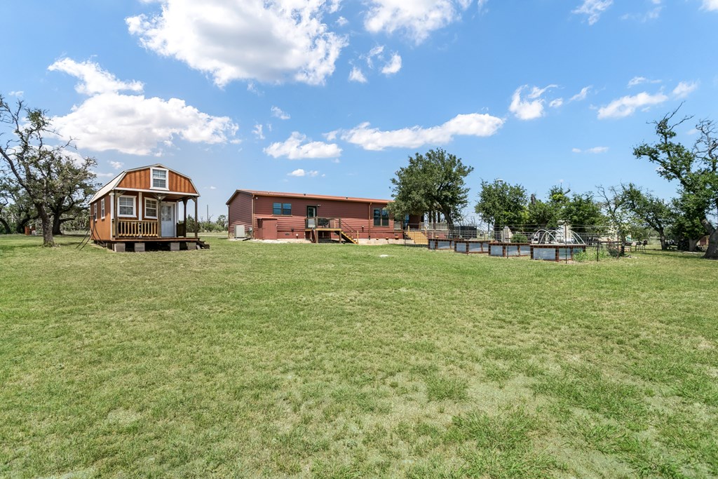 134 Concho Trail Harper, TX 78631 - Photo 23 of 31 a view of a house with a big yard and a large tree