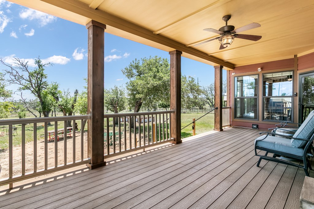 134 Concho Trail Harper, TX 78631 - Photo 3 of 31 a view of a balcony with couch and wooden floor