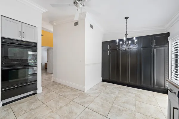 a view of empty room with window and cabinet