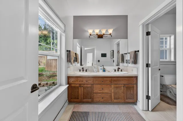 a bathroom with a tub sink and mirror