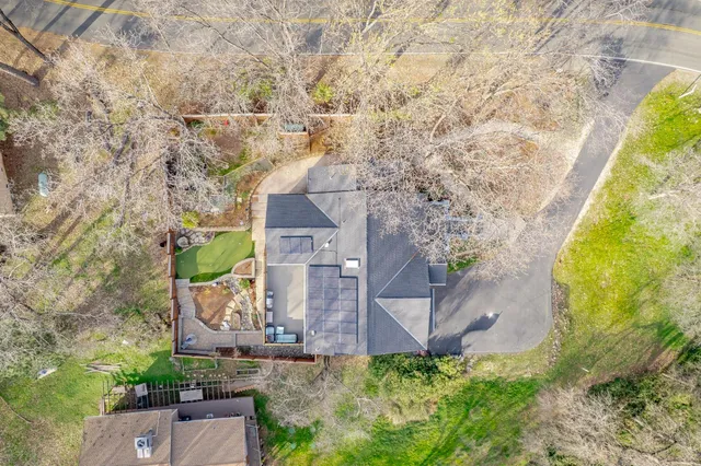 an aerial view of a house with a yard