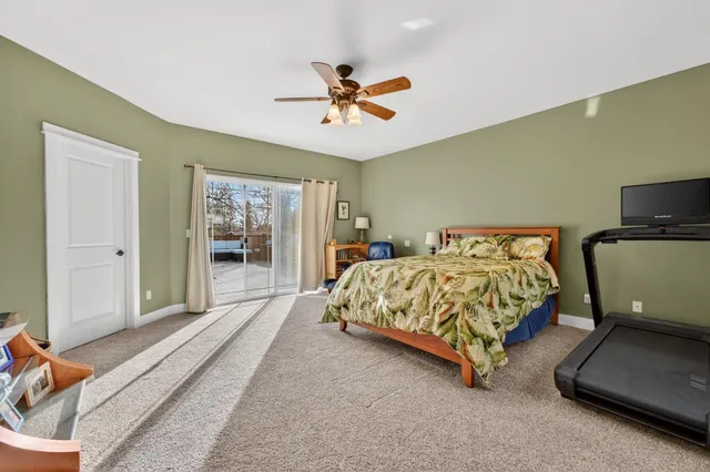 a bedroom with a bed and glass door
